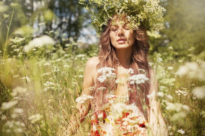 Caucasian woman enjoying wildflowers in field