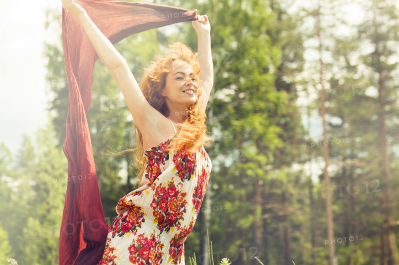 Caucasian woman holding scarf in wind