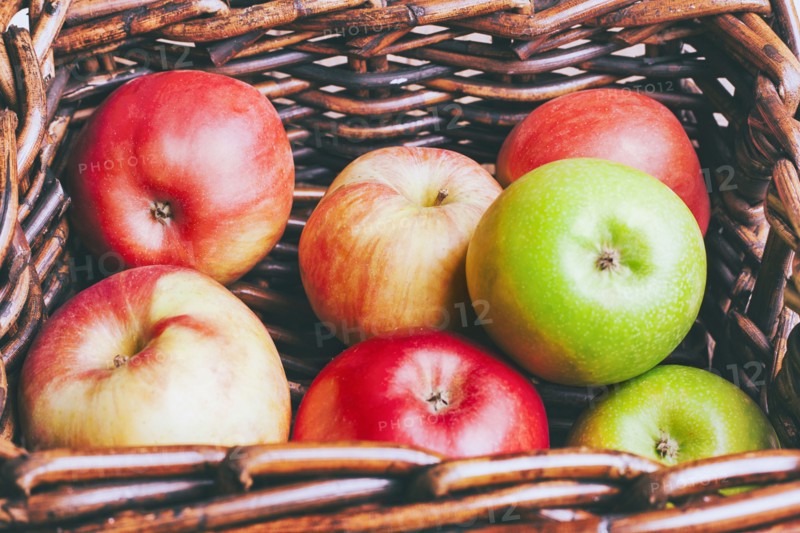 Basket of apples on wooden table