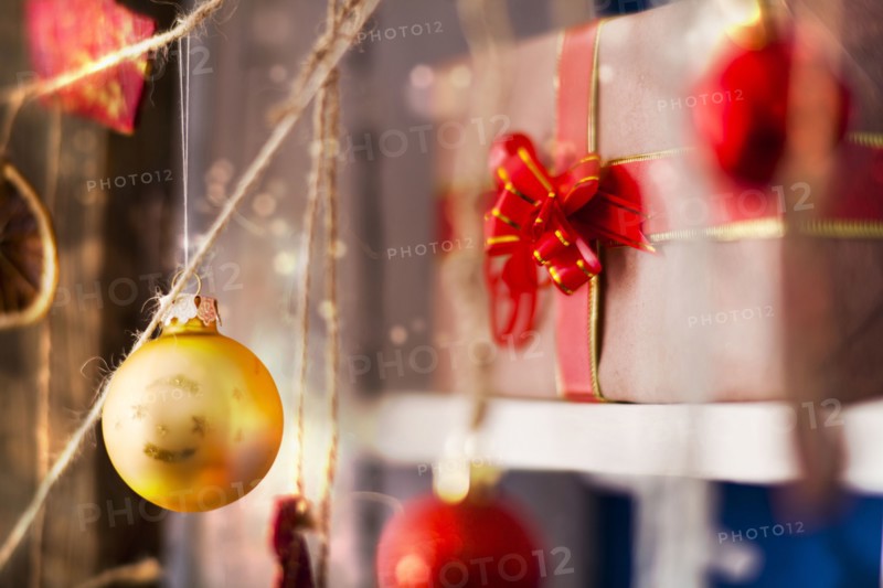 Ornaments hanging on string near gift box