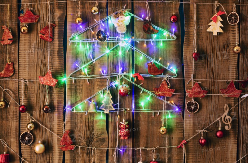 Christmas ornaments hanging on string on wood