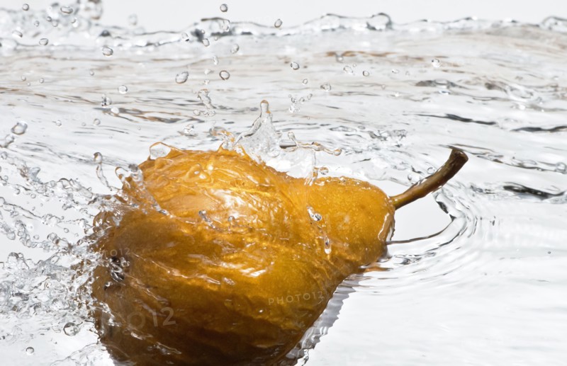 Close up of pear splashing in water