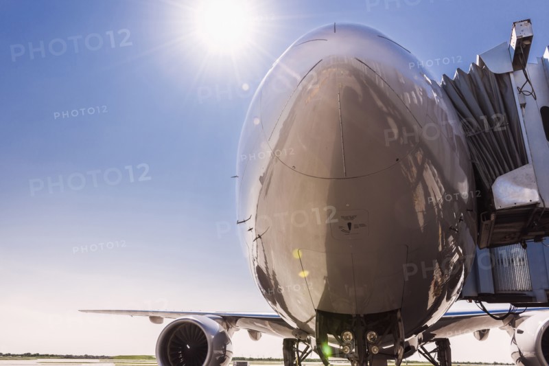 Low angle view of airplane at airport under blue sky