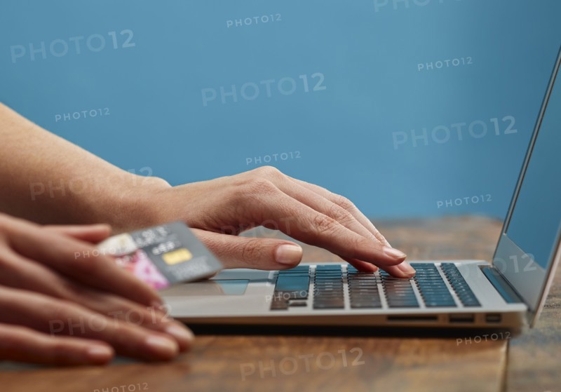 Hands of woman online shopping with laptop