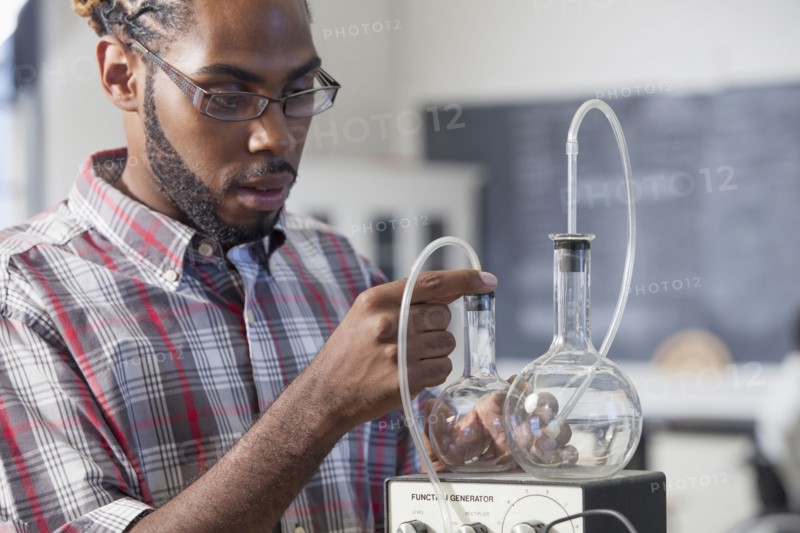 Student performing experiment in science classroom