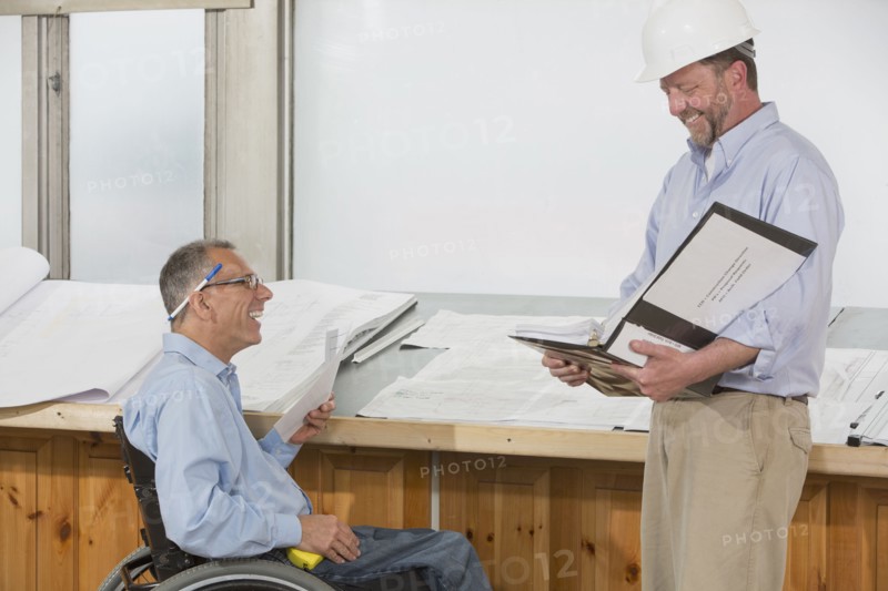 Caucasian architects talking in office