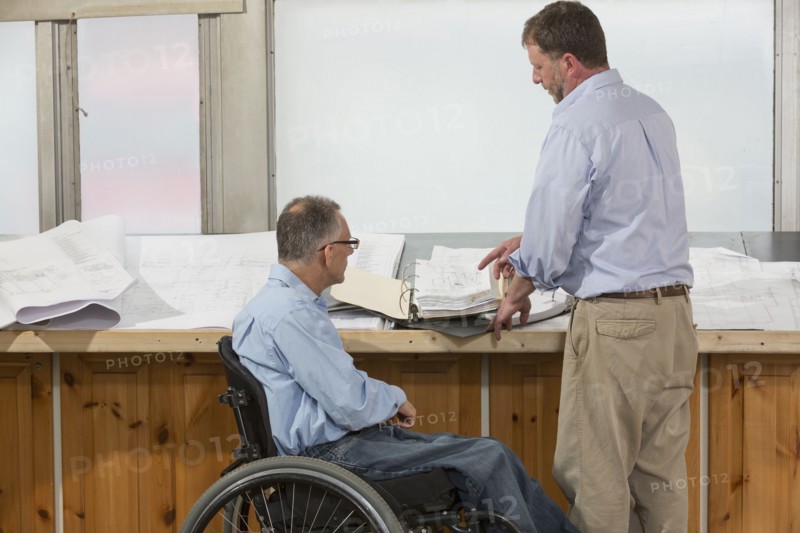 Caucasian architects talking in office