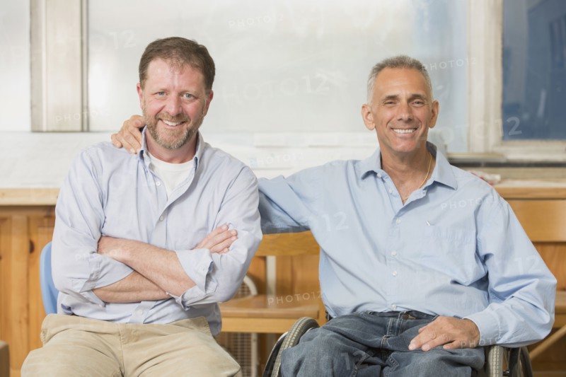 Caucasian businessmen smiling in office