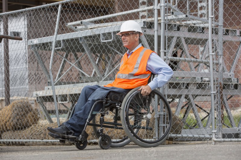 Caucasian engineer in wheelchair on construction site