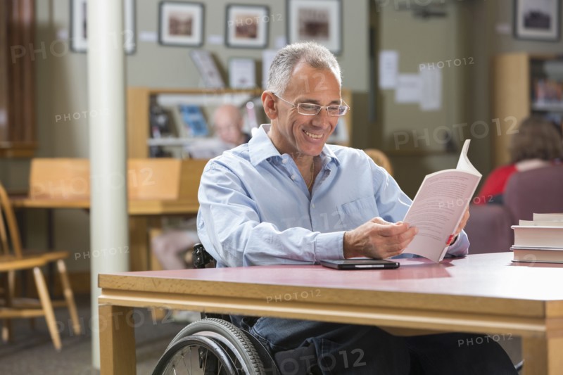 Caucasian man reading in library