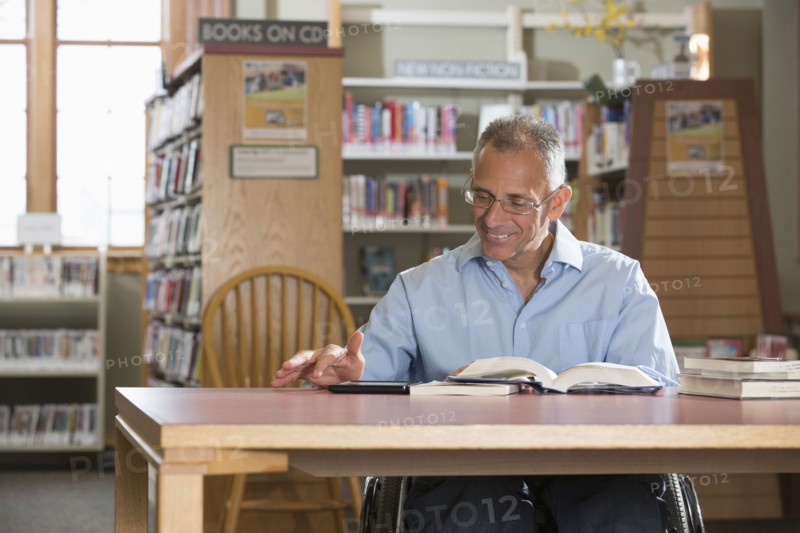 Caucasian man reading in library