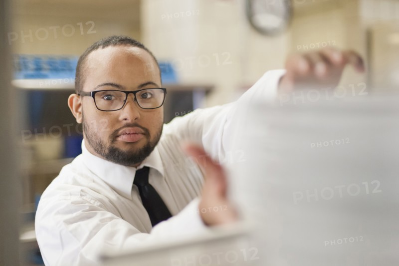Mixed race server with down syndrome working in restaurant