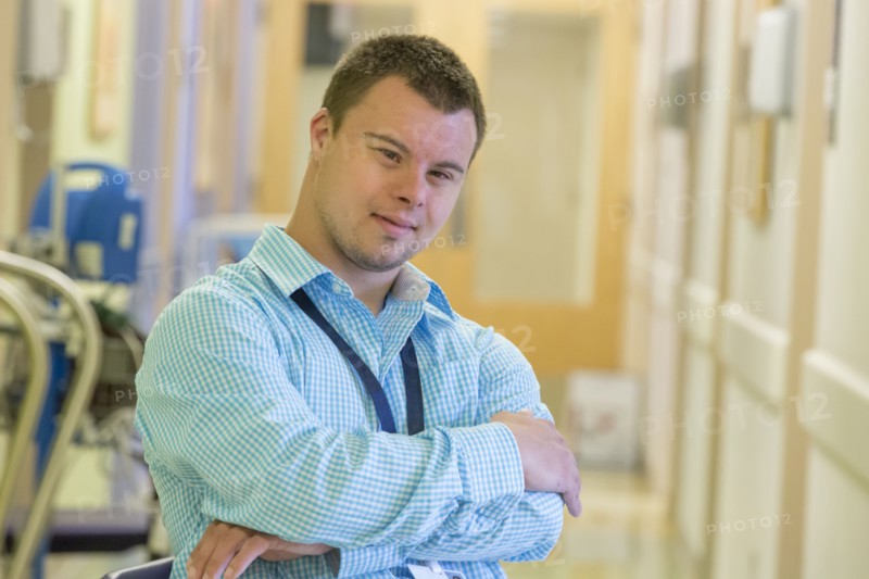 Caucasian man with Down Syndrome working in hospital