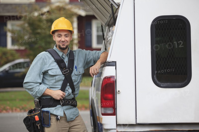Caucasian worker smiling at truck
