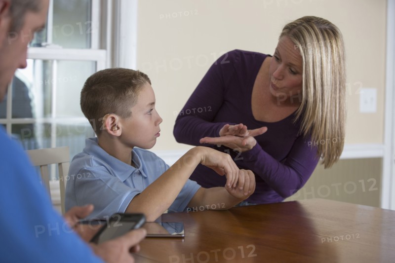 Caucasian mother signing with deaf son