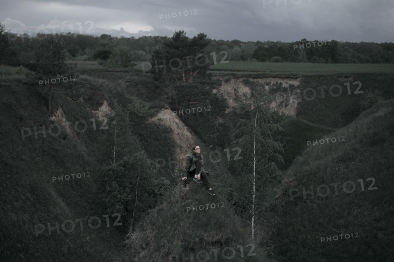 Caucasian woman sitting on hill