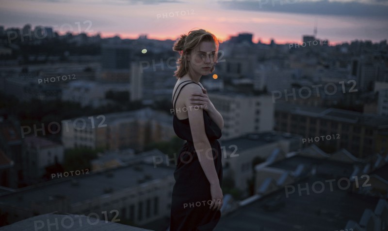 Portrait of serious Caucasian teenage girl overlooking cityscape
