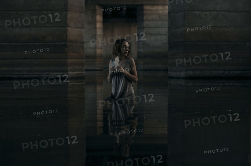 Caucasian woman standing waist deep in water