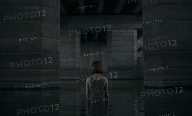 Caucasian woman standing waist deep in water
