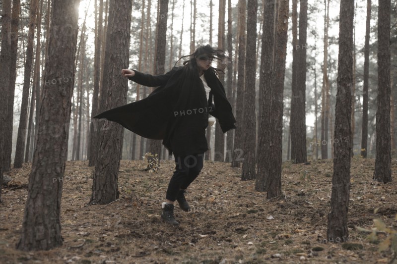 Caucasian woman dancing in forest