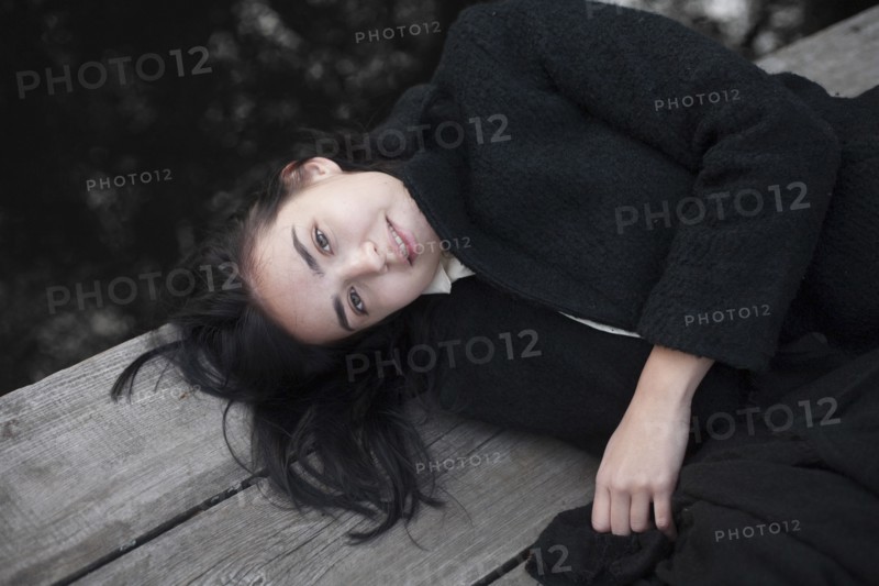 Portrait of Caucasian woman laying on wood
