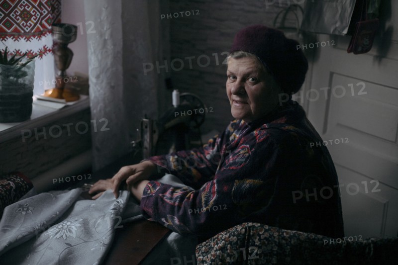 Older Caucasian woman using sewing machine