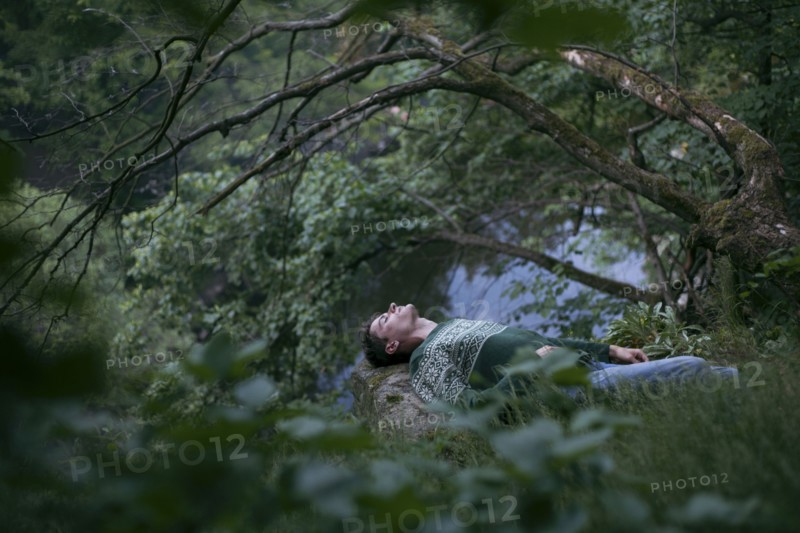 Caucasian man relaxing in woods