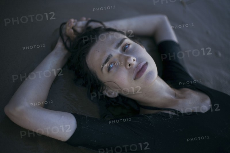 Caucasian woman laying on beach