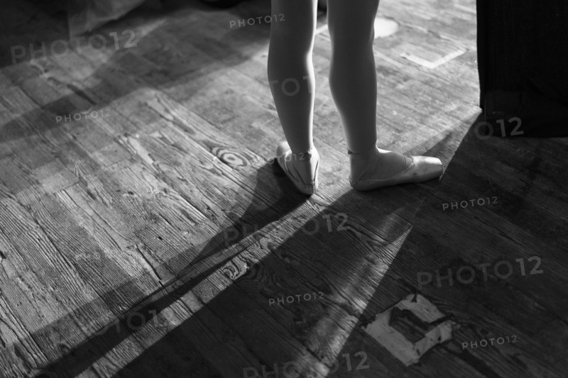 Legs of woman wearing ballet shoes