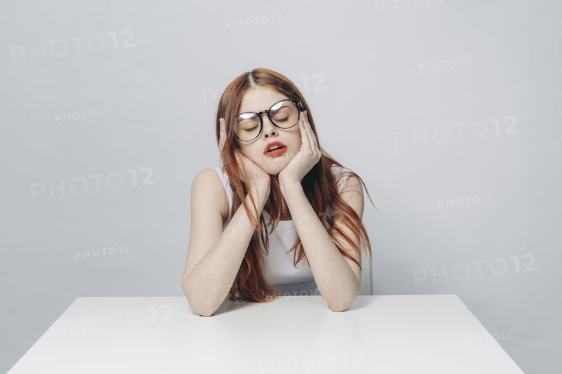 Frustrated Caucasian woman sitting at table