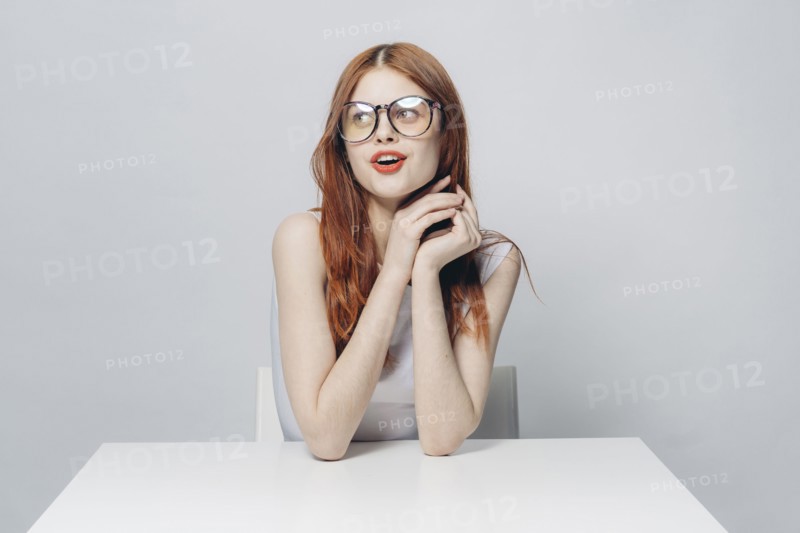 Happy Caucasian woman sitting at table