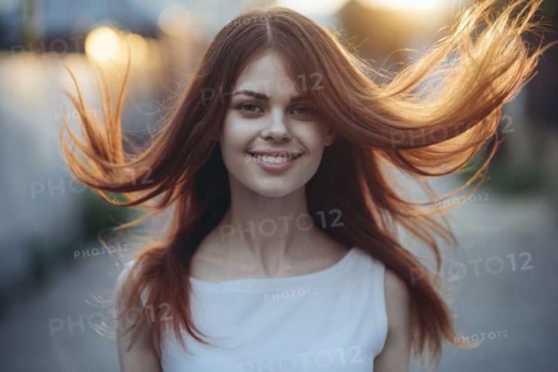 Wind blowing hair of smiling Caucasian woman