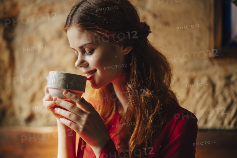 Caucasian woman sipping cup of tea