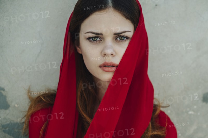 Serious Caucasian woman wearing red headscarf