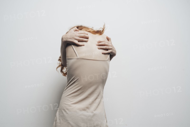 Caucasian woman hugging shoulders