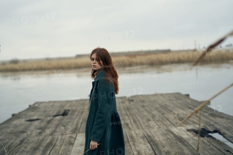 Serious Caucasian woman standing on dock