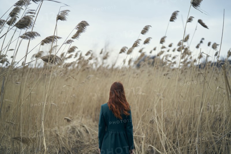 Rear view of Caucasian woman standing in field