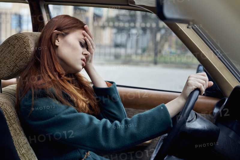 Frustrated Caucasian woman driving car