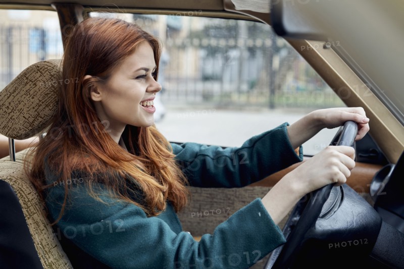Smiling Caucasian woman driving car