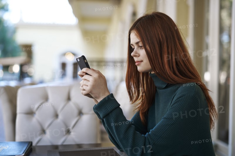 Caucasian woman texting on cell phone at restaurant