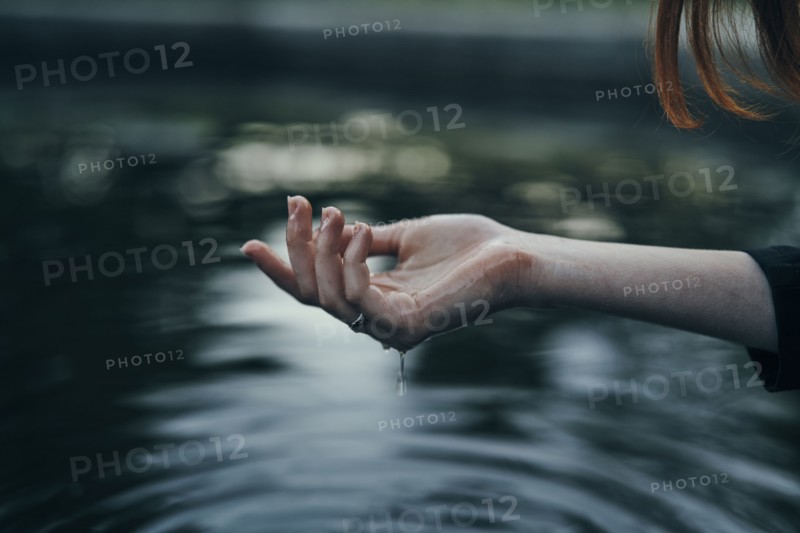 Water dripping from hand of woman
