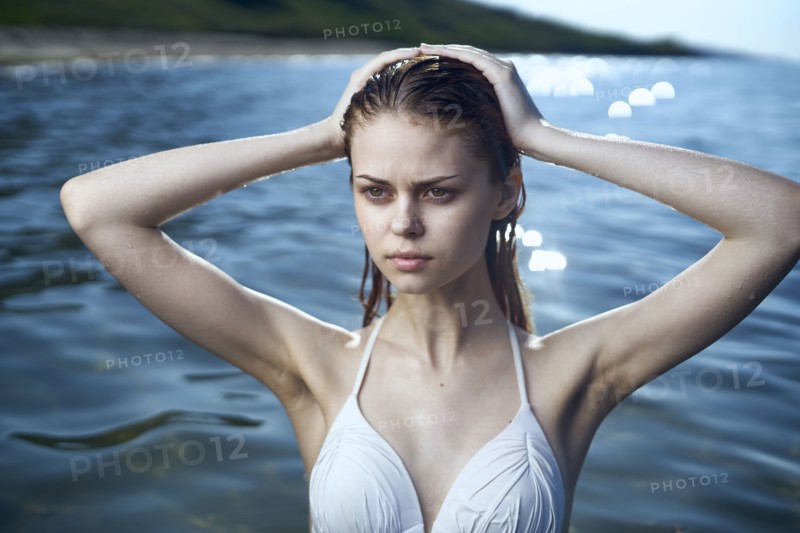 Serious woman wearing a bikini in ocean