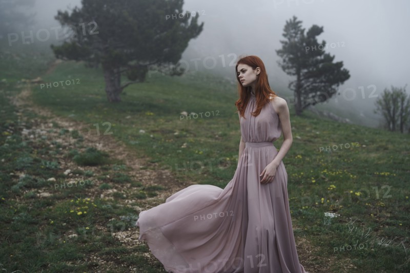 Caucasian woman wearing a dress in field