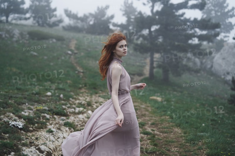 Wind blowing hair of Caucasian woman in field