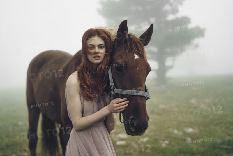 Caucasian woman petting horse