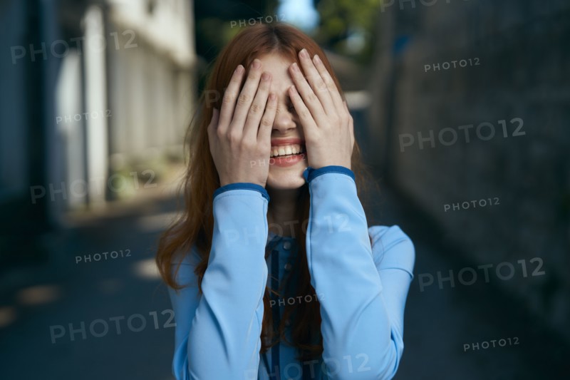 Caucasian woman covering eyes with hands