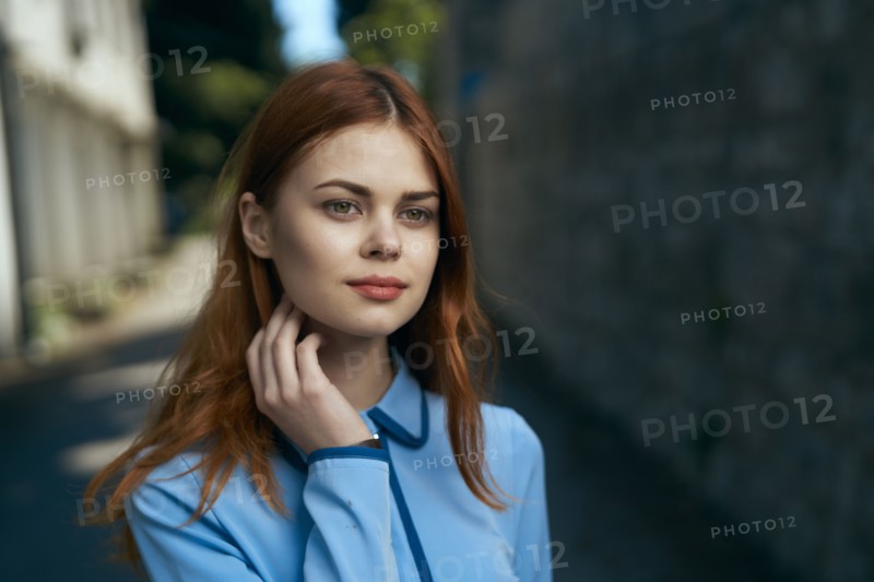 Pensive Caucasian woman near stone wall