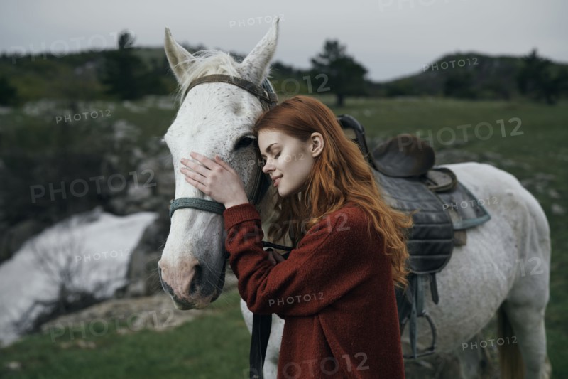 Caucasian woman petting horse