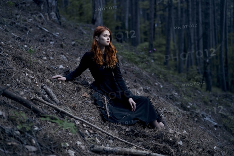 Caucasian woman sitting on hill