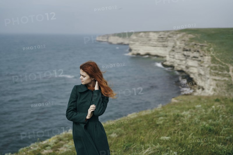 Caucasian woman standing near ocean